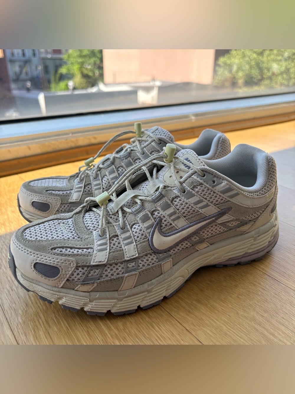 Nike P-6000 Women’s Athletic Sneakers in white, lavender and grey.